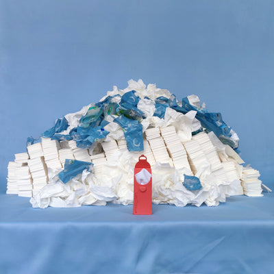 LastTissue Peach in front of mountain of single use tissues
